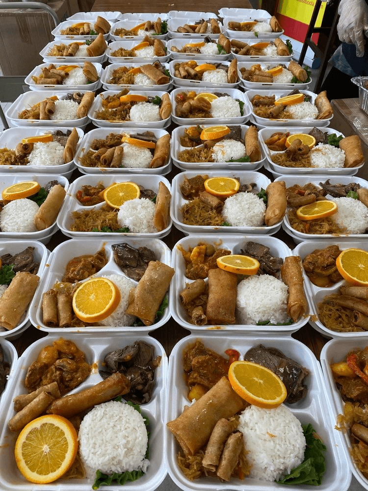 Beautifully plated Filipino catering trays with warm lighting